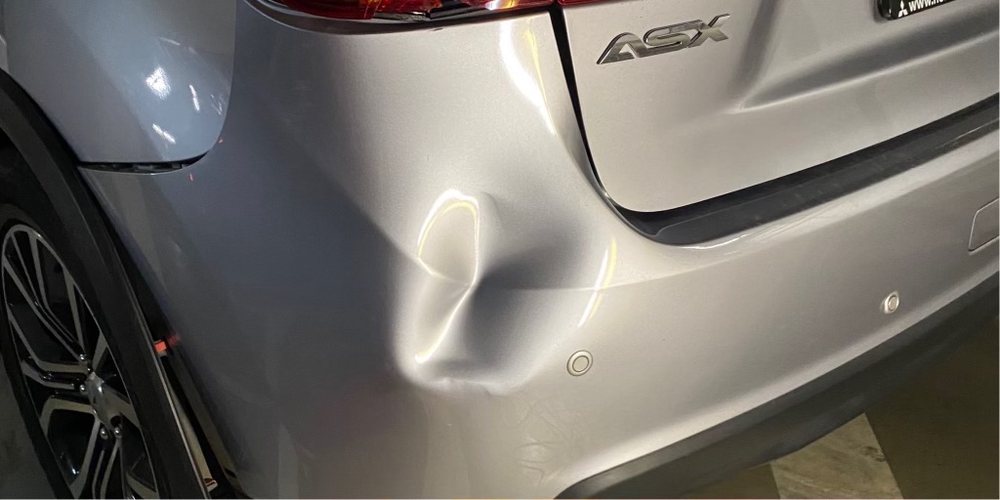 Nissan ASX rear quarter dent: drag to compare (before repair)